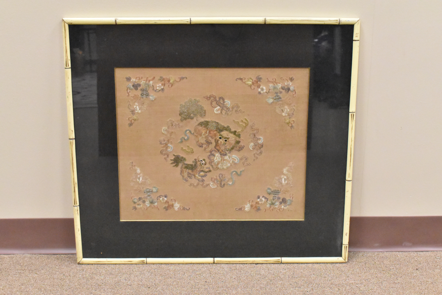 Appraisal: A mounted and framed embroidery silk panel with foo lions