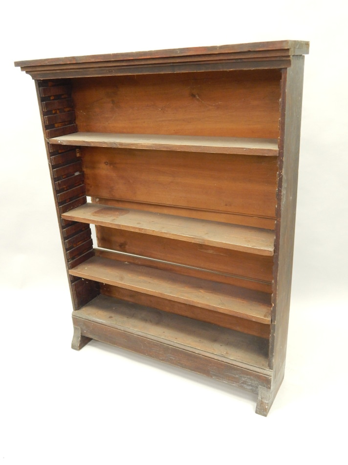 Appraisal: A stained pine open bookcase on shaped feet cm wide