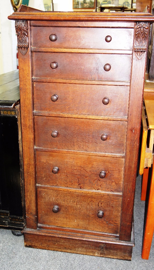 Appraisal: A Victorian oak Wellington chest the six graduated drawers enclosed