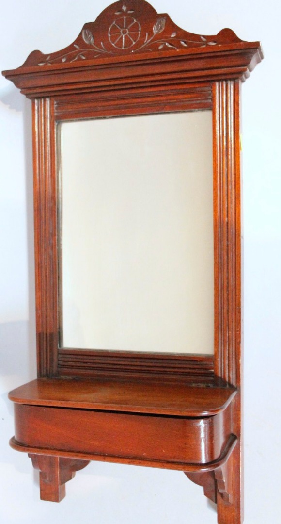 Appraisal: An Edwardian mahogany framed hanging mirror the plain rectangular glass