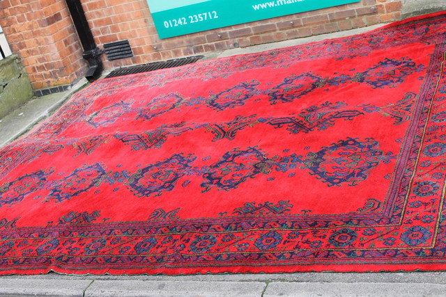 Appraisal: A LARGE TURKEY WOOL CARPET of red ground form with