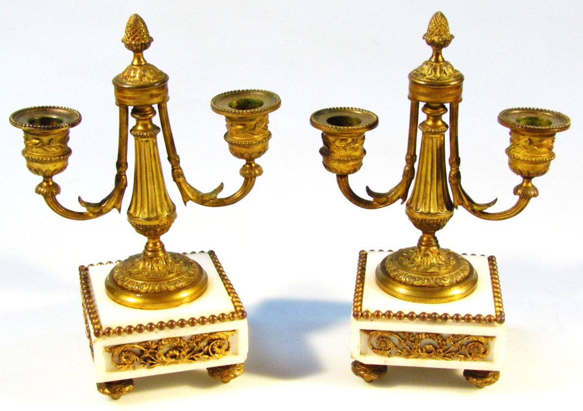 Appraisal: A pair of Regency brass and marble garniture candlesticks each