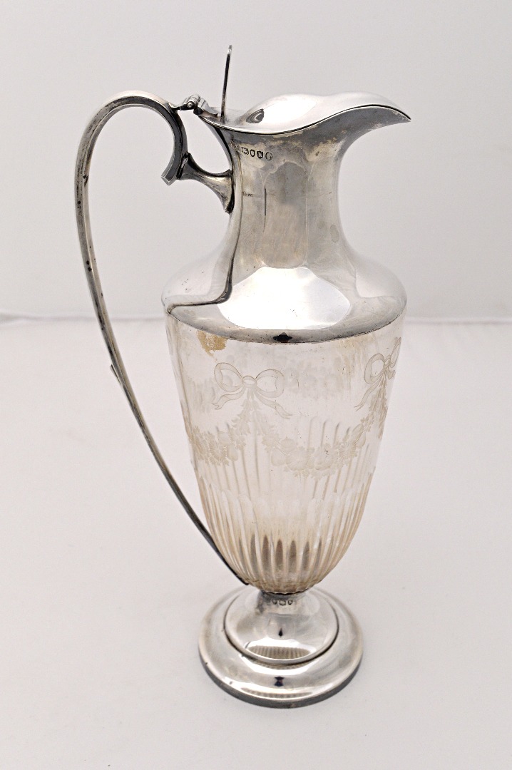 Appraisal: A Victorian silver mounted glass claret jug the body with