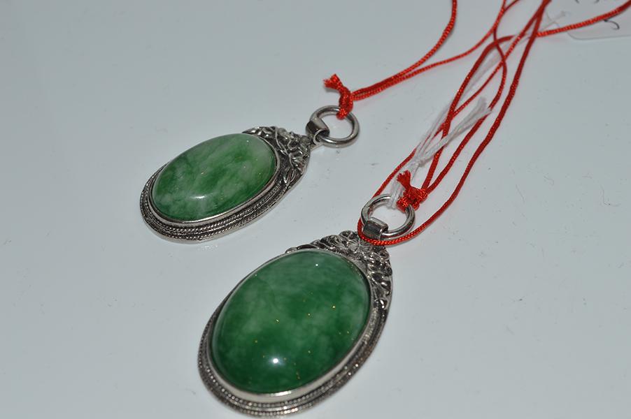 Appraisal: TWO TREATED JADE PENDANTS IN SILVER MOUNTS TWO TREATED JADE