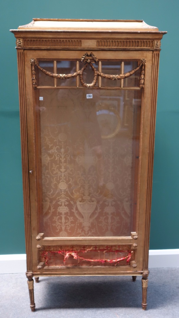 Appraisal: An early th century gilt framed display cabinet the single