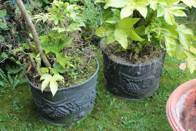 Appraisal: A PAIR OF SPHERICAL FAUX LEAD COMPOSITE PLANTERS each with