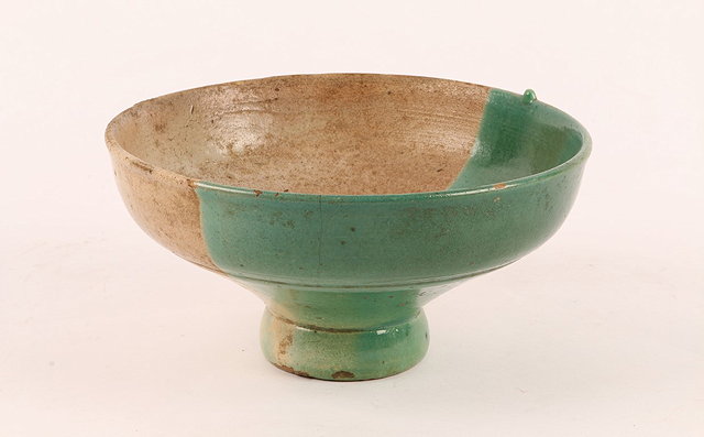 Appraisal: A MIDDLE EASTERN POTTERY STEM BOWL with half green glaze