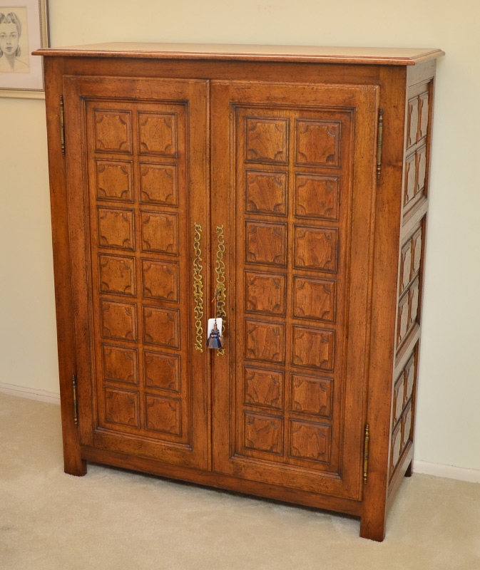 Appraisal: DON RUSEAU CARVED WALNUT GENTLEMENS CHEST door tall chest by