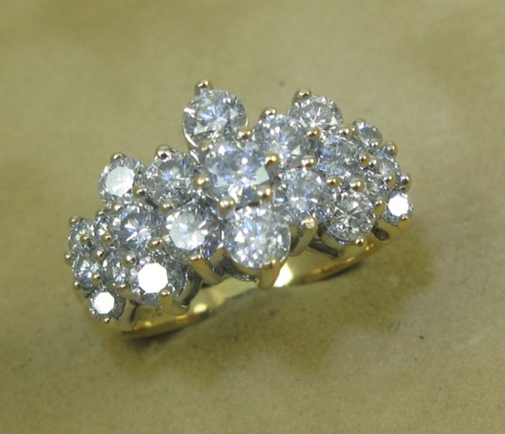 Appraisal: DIAMOND AND FOURTEEN KARAT GOLD RING set with round-cut diamonds