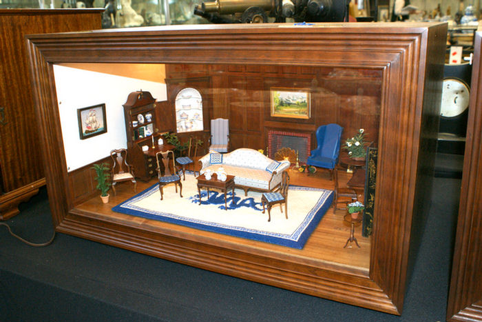 Appraisal: Diorama of a colonial paneled LR with fireplace sofa blue