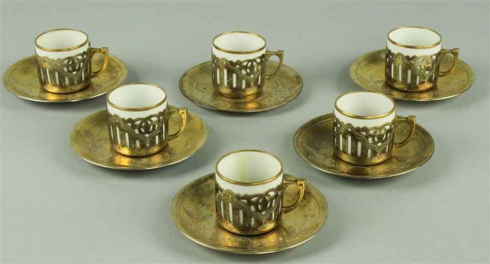 Appraisal: EGYPTIAN SILVER GILT AND PORCELAIN DEMITASSE SET containing cups and