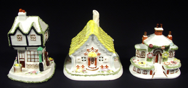 Appraisal: Three Coalport 'Cottage' pastille burners with hand painted decoration 'The