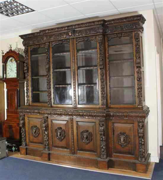 Appraisal: A Victorian carved oak breakfront library bookcase decorated throughout with