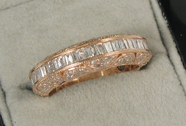 Appraisal: DIAMOND AND ROSE GOLD RING with channel set baguette diamonds