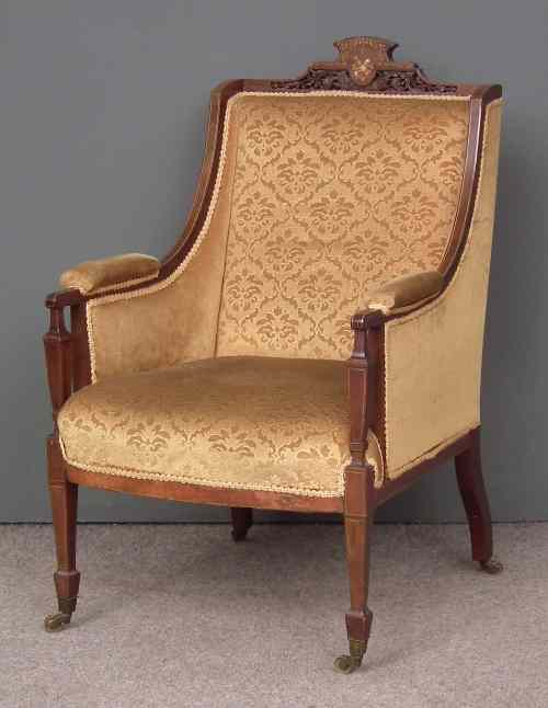 Appraisal: An Edwardian mahogany framed wing back easy chair inlaid with