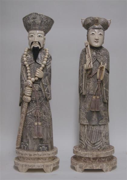 Appraisal: Tall pair of Chinese stained bone figuresModeled as a standing