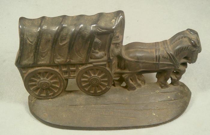 Appraisal: Cast iron doorstop brown hollow back horse-drawn covered wagon on