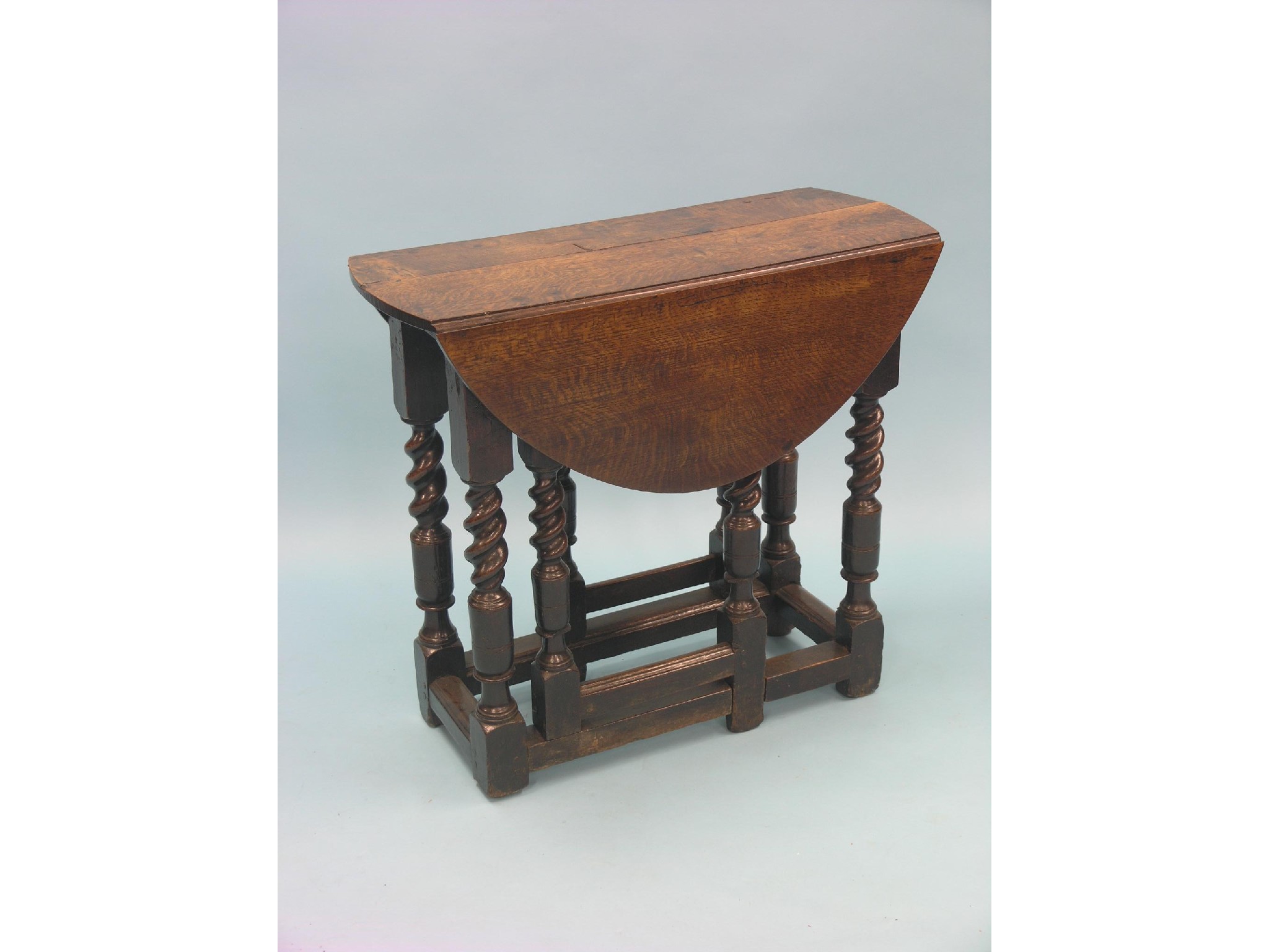 Appraisal: A late th century oak gateleg table barley-twist underframe with