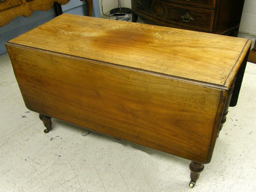 Appraisal: Victorian mahogany drop-leaf dining table supported upon turned circular legs