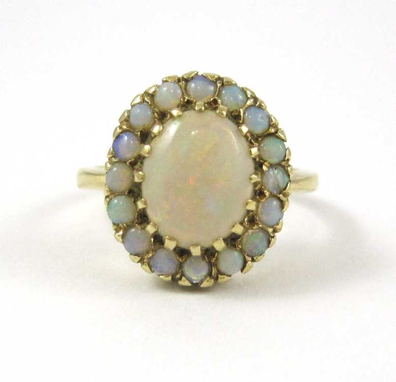 Appraisal: OPAL AND FOURTEEN KARAT GOLD RING with round opal cabochons