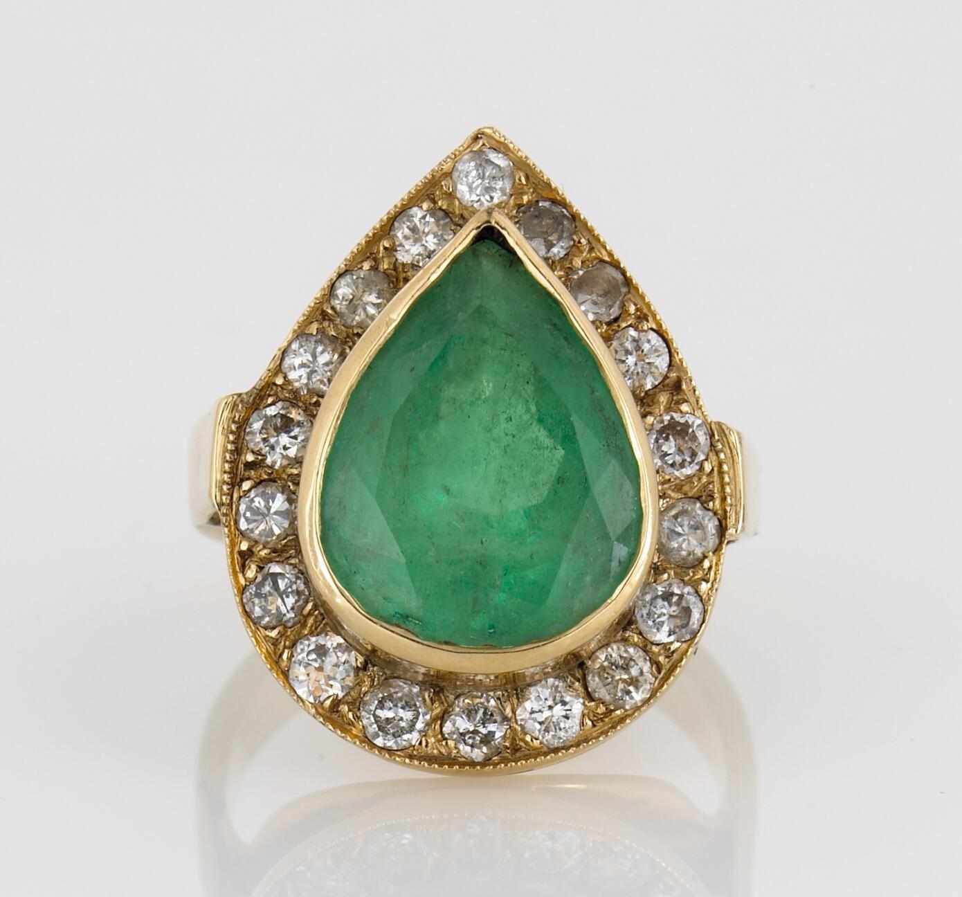 Appraisal: An emerald and diamond ring centering a pear-shaped emerald weighing