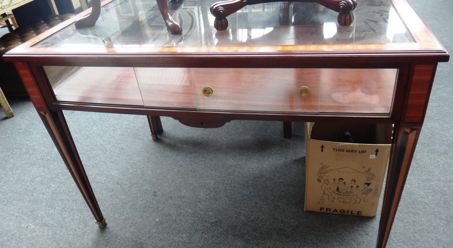 Appraisal: A th century French mahogany tulipwood inlaid display table on