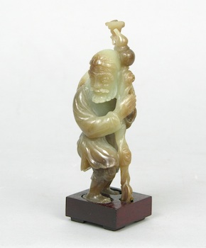 Appraisal: A Carved Hardstone Figurine of a Beggar on a Stand