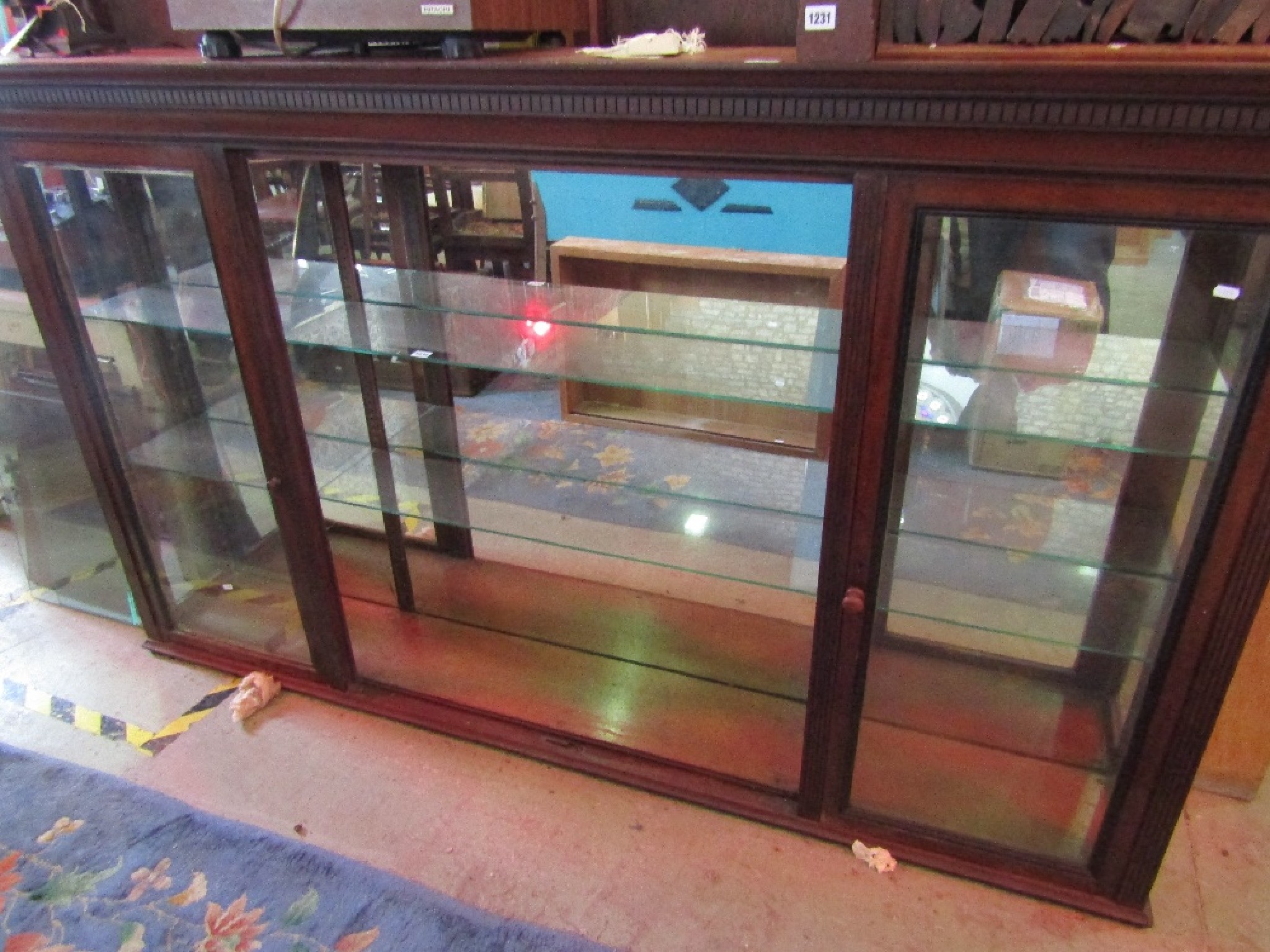 Appraisal: A th century mahogany shop display cabinet the moulded cornice