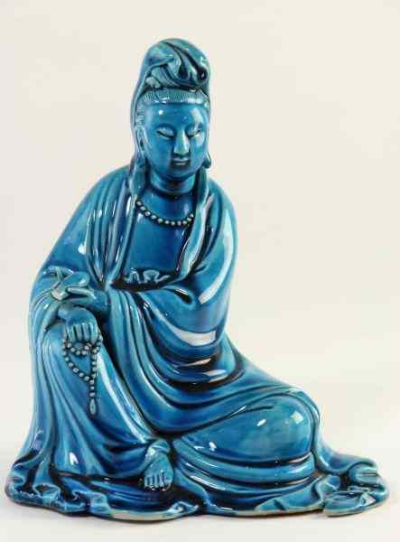 Appraisal: Figure of GuanyinChinese white porcelain in a turquoise glaze in