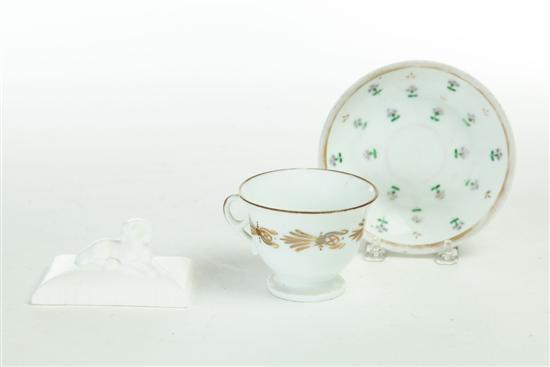 Appraisal: CUP AND SAUCER AND PAPERWEIGHT American porcelain Cup in gilded