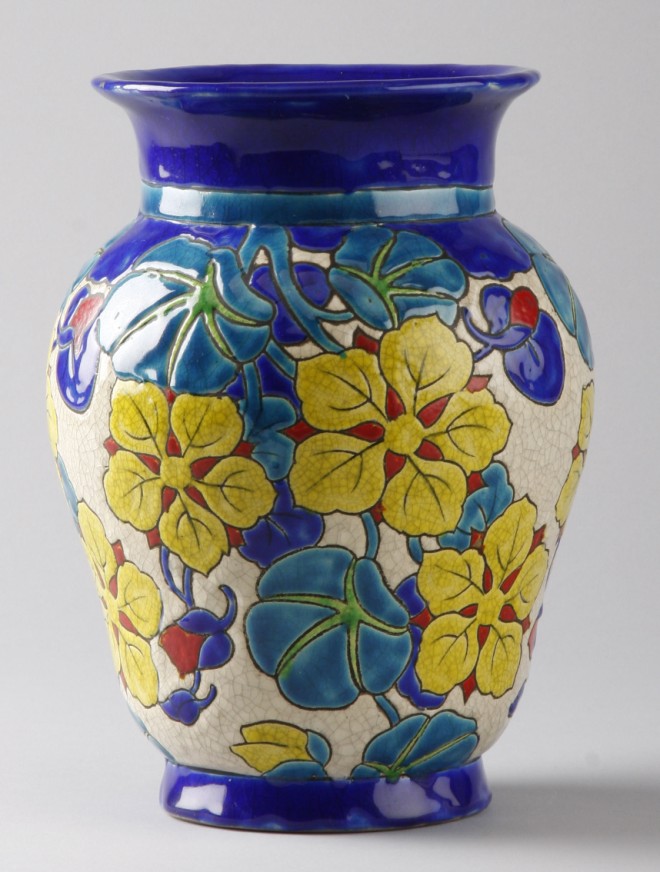 Appraisal: Vase features colorful flowers with cobalt blue neck and border