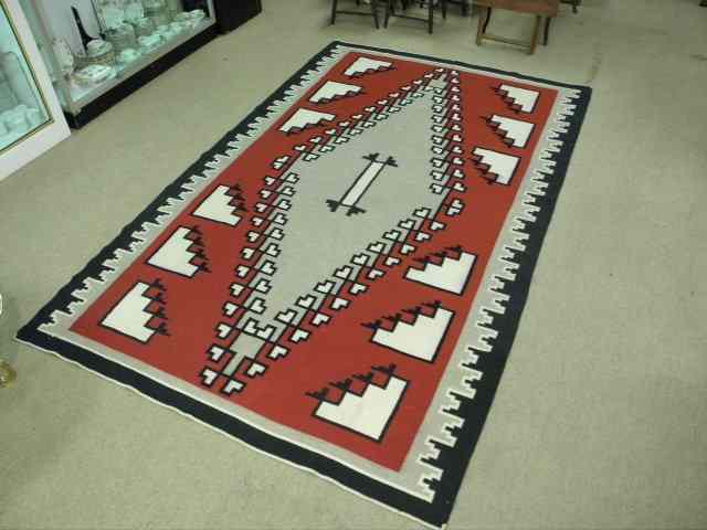 Appraisal: A Native American wool area rug with a black red