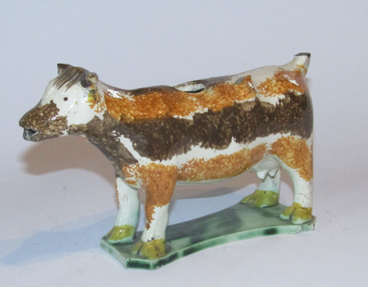 Appraisal: An early thC Staffordshire Prattware cow creamer the main body