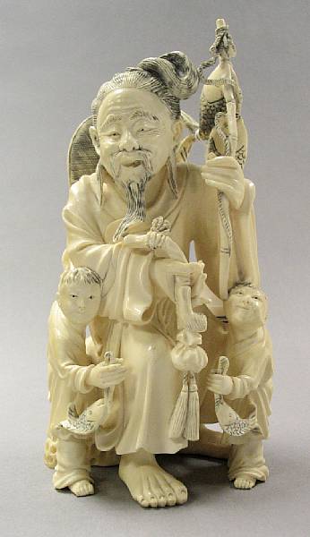 Appraisal: A carved ivory fishman with his sons With the man