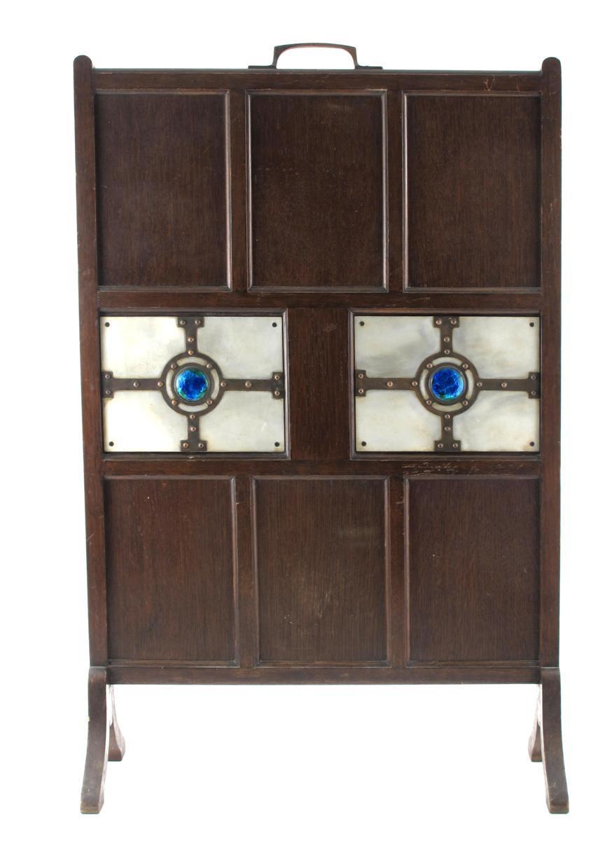 Appraisal: An oak panelled fire screen