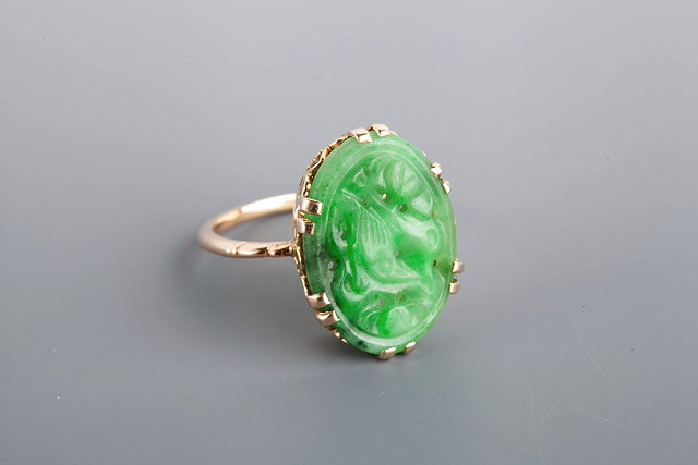 Appraisal: A JADE SET DRESS RING carved oval panel set with