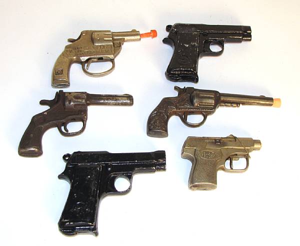 Appraisal: Cast iron toy guns Assorted porcelain and cast iron examples