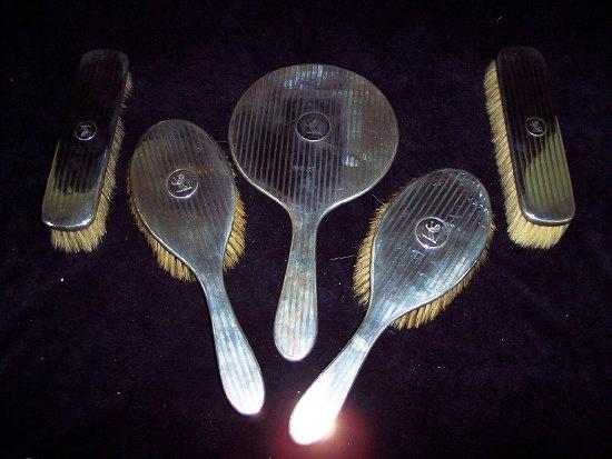 Appraisal: A dressing table set comprising a pair of clothes brushes