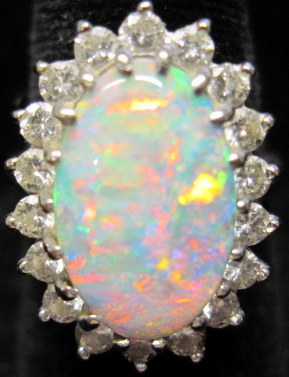 Appraisal: Opal and diamond ring Oval opal accented by petite round