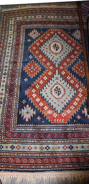 Appraisal: AN EASTERN BLUE GROUND WOOL RUG with central medallion and