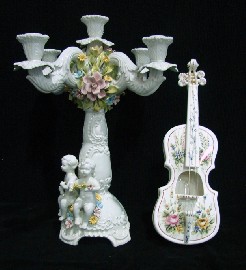 Appraisal: An Italian Bassano five branch candelabra modelled with applied putti