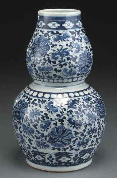 Appraisal: Chinese Qing blue and white double gourd porcelainvase depicting scrolling