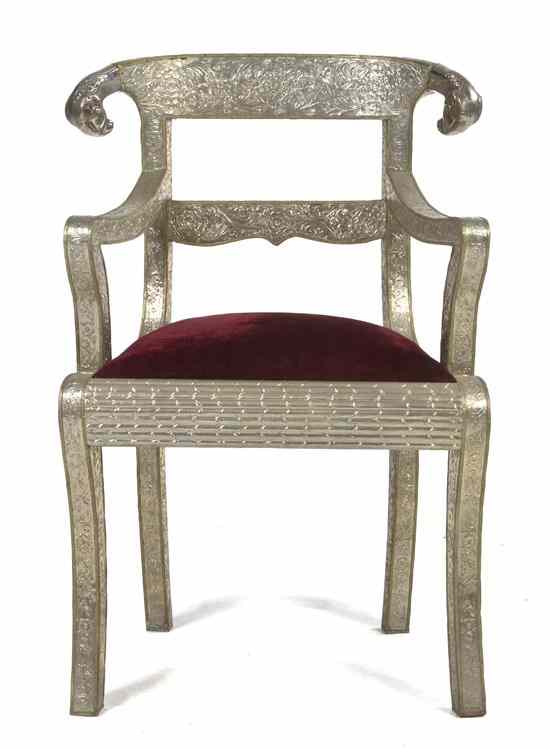 Appraisal: An Indian Silvered Metal Veneered Open Armchair having ram mask