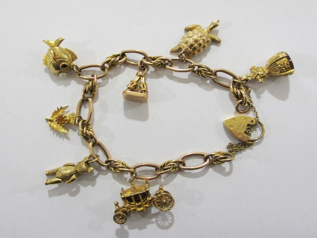 Appraisal: Nine carat gold charm bracelet with seven various ct gold