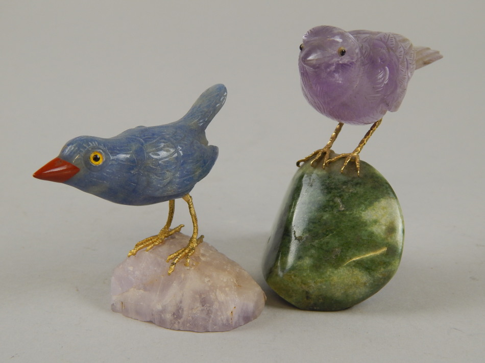 Appraisal: Two carved hardstone birds comprising a purple translucent bird with