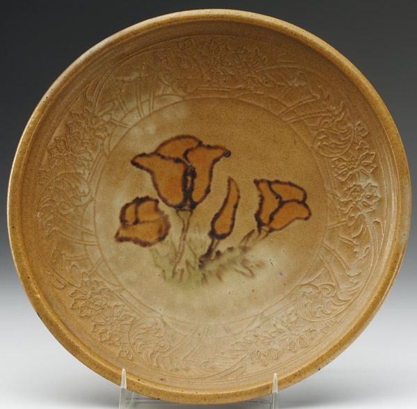 Appraisal: AREQUIPA Plate painted with amber flowers surrounded by carved floral