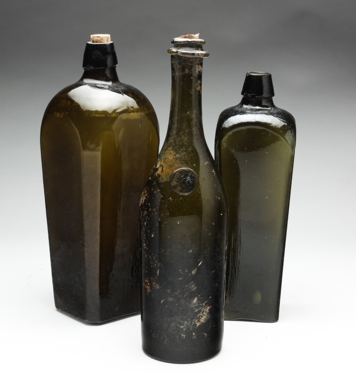 Appraisal: THREE ENGLISH BLOWN GLASS BOTTLES Late th-early th century Olive