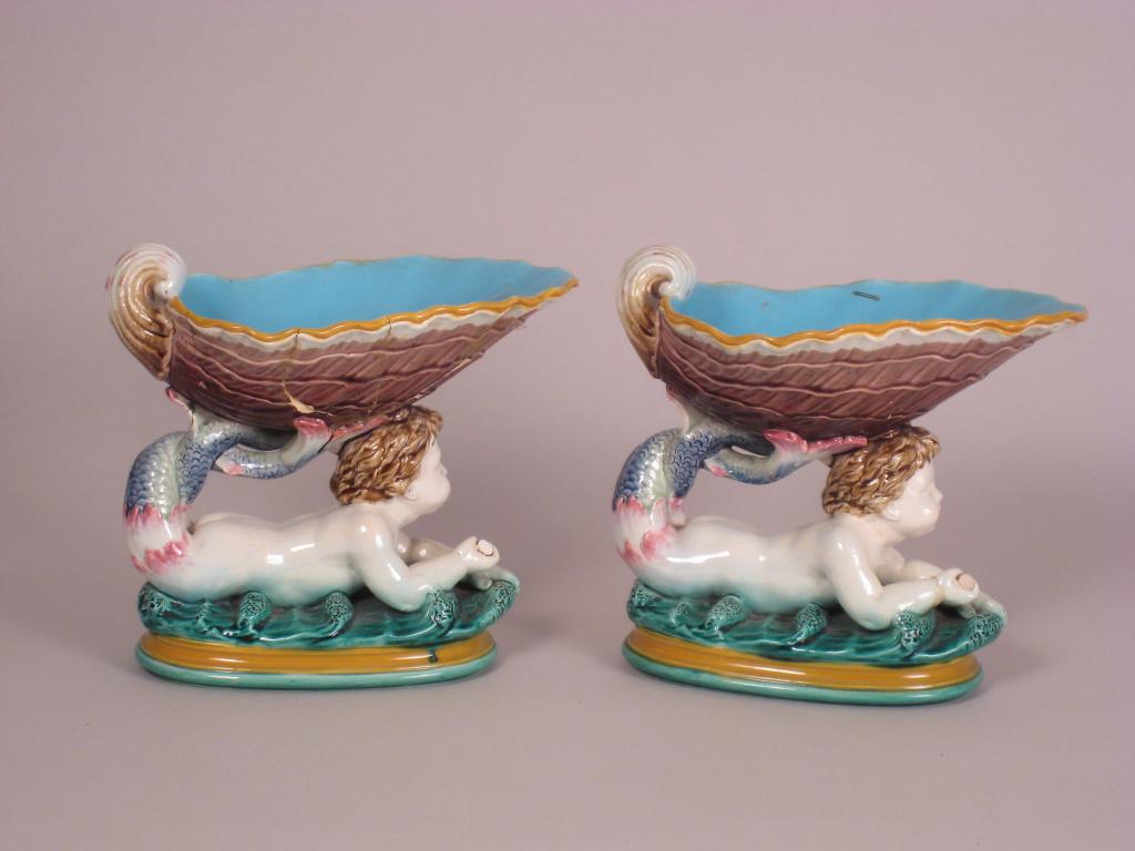 Appraisal: Pair of Minton majolica shells supported by putto both A