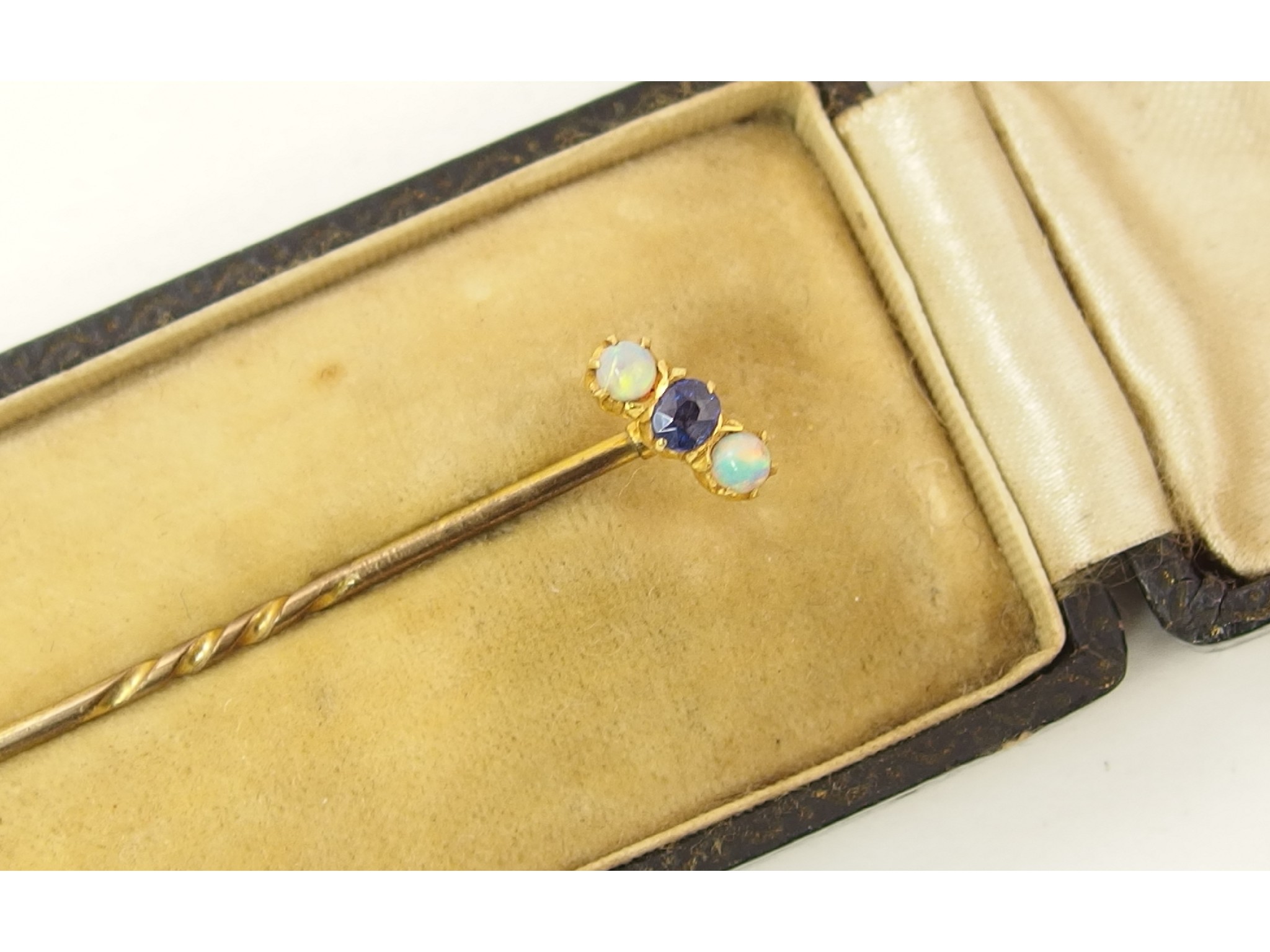 Appraisal: A sapphire and opal set stick pin set in ct