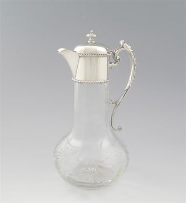 Appraisal: A plated mounted clear glass claret jug the baluster body